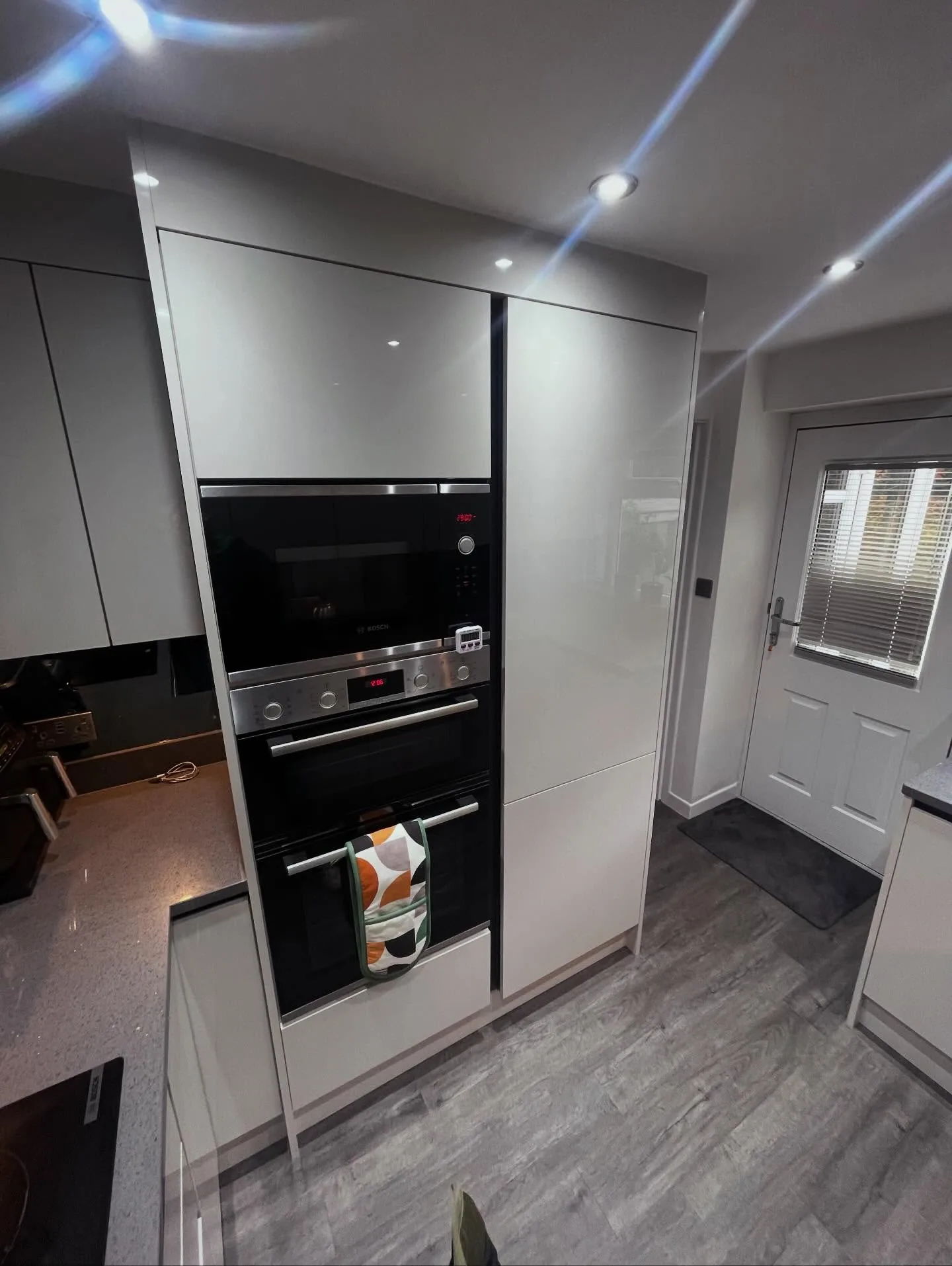 White gloss kitchen tall unit with built-in double ovens